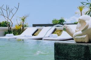 a pool with a water slide in a resort at Allia Residence in Nusa Dua