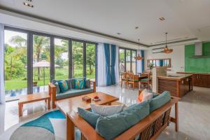 a living room with a couch and a table at Danang Villas Complex in Da Nang