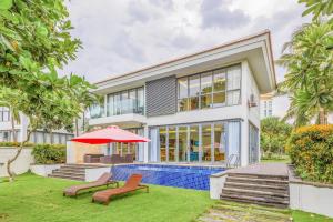 a house with a swimming pool and a patio at Danang Villas Complex in Danang