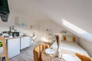 une chambre avec un lit et une table et une cuisine dans l'établissement Everman Anzin, à Anzin