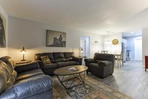 a living room with a leather couch and a table at Western Comfort in Branson