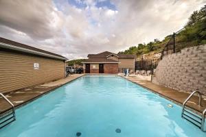 a large swimming pool with blue water in front of a house at Western Comfort in Branson