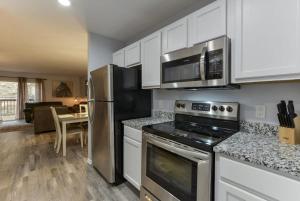 a kitchen with stainless steel appliances and white cabinets at Western Comfort in Branson
