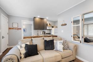 a living room with a couch and a kitchen at Wake Zone Lighthouse Lodge - Lake Views in Kimberling City