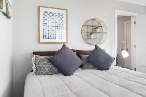 a bedroom with a large white bed with pillows at Wake Zone Lighthouse Lodge - Lake Views in Kimberling City