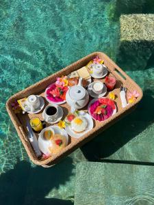 a tray of food on a table next to a pool at D'Avera Villa Canggu in Canggu