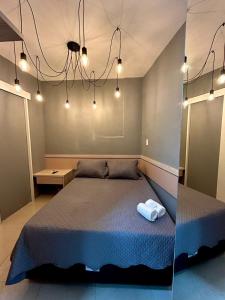 two pictures of a bedroom with a bed and lights at Cine Rio Hostel RJ in Rio de Janeiro +40 photos