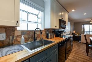 a kitchen with a sink and a counter top at Libby's Perch No Stairs Outdoor Pool in Branson +27 photos