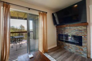 a living room with a fireplace and a television at Libby's Perch No Stairs Outdoor Pool in Branson