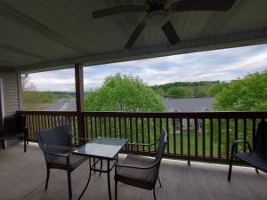 a patio with a table and chairs on a balcony at Placid Place Walk to Marina Fishing in Branson