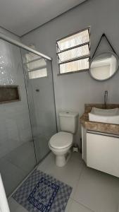 a bathroom with a toilet and a shower and a sink at Casa Porto Mar in Aracaju +8 photos
