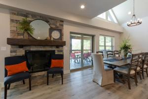 a dining room with a fireplace and a table and chairs at Journey's Remedy -Lake View Sleeps 30 in Branson