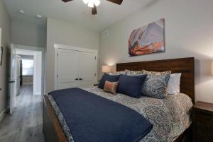 a bedroom with a large bed with blue pillows at Journey's Remedy -Lake View Sleeps 30 in Branson +73 photos