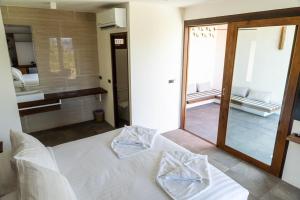 a bedroom with a white bed and a mirror at Mae Ya Resort in Ko Tao