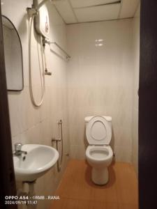 a bathroom with a toilet and a sink at perfect class hotel in Kuala Lumpur