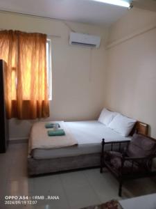 a small bedroom with a bed and a window at perfect class hotel in Kuala Lumpur