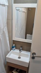 a bathroom with a white sink and a mirror at Nice San Telmo in Buenos Aires +17 photos