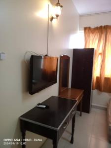 a living room with a tv and a table at perfect class hotel in Kuala Lumpur +36 photos