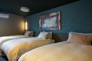 Postel nebo postele na pokoji v ubytování Villa 石の蔵 Hotel
