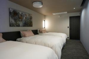 Postel nebo postele na pokoji v ubytování Villa 石の蔵 Hotel