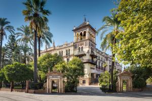 a building with a clock tower on top of it at Hotel Alfonso XIII, a Luxury Collection Hotel, Seville in Seville