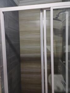a glass door of a closet with a wooden wall at Single room for 1 in Vereeniging