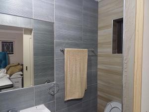a bathroom with a sink and a mirror at Single room for 1 in Vereeniging