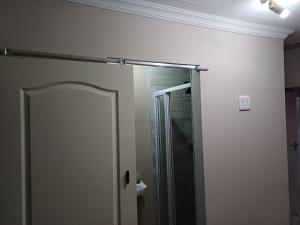 a bathroom with a shower and a glass door at Single room for 1 in Vereeniging