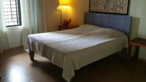 A bed or beds in a room at Magnolia Guesthouse Varkala