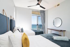 a hotel room with two beds and a mirror at Coastal View @ 1304 La Ballito in Ballito