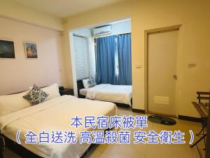 a hotel room with two beds and a window at Qin's House II in Jinning