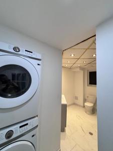 a washing machine in a room with a bathroom at Entire bungalow, full privacy, free parking in Oshawa