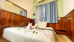 A bed or beds in a room at The Center Point