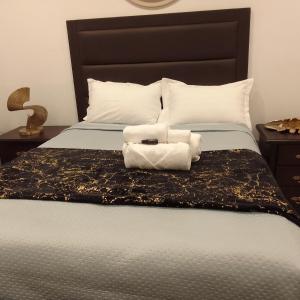a bedroom with a bed with two towels on it at Elegant BnB in Bulawayo