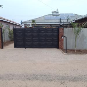 a large black garage door in a house at Elegant BnB in Bulawayo