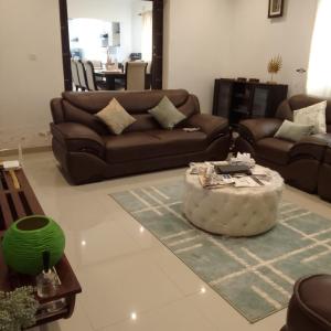a living room with a couch and a coffee table at Elegant BnB in Bulawayo