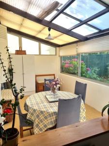 a dining room with a table and chairs and a window at Maison chaleureuse près Disney in Villenoy