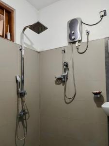 a shower with a shower head in a bathroom at ECO Canal Suite in Polonnaruwa +46 photos