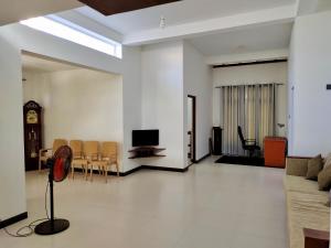 a living room with a tv and a table and chairs at ECO Canal Suite in Polonnaruwa