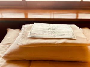 Postel nebo postele na pokoji v ubytování SAMURISE DARUMA