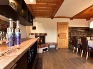 a kitchen with a bar with bottles of wine at Apartment in Schwalbenhof farm in Haselbach