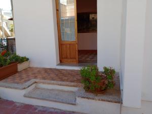 an entrance to a house with a door and some plants at casa vacanze marinela in Casarano