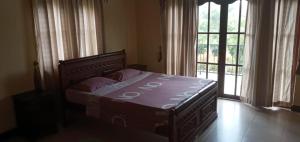 Ένα ή περισσότερα κρεβάτια σε δωμάτιο στο Nil Diya Villa