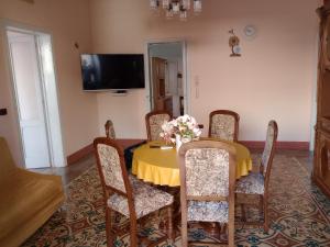 a dining room with a yellow table and chairs at casa vacanze marinela in Casarano
