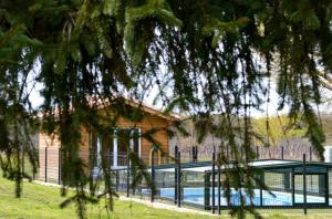 a house with a swimming pool in front of a building at Maison d'Hôtes La Prévôté in Périssac