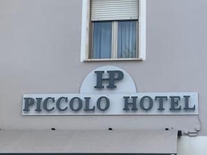 a sign for a hotel on the side of a building at Piccolo Hotel in Rosignano Solvay