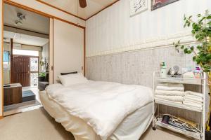 Un ou plusieurs lits dans un hébergement de l'établissement Momodani 72 two-story detached house