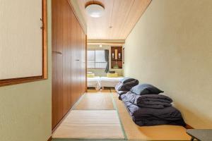 Un ou plusieurs lits dans un hébergement de l'établissement Momodani 72 two-story detached house