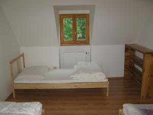 A bed or beds in a room at Chalupa U Kurišky