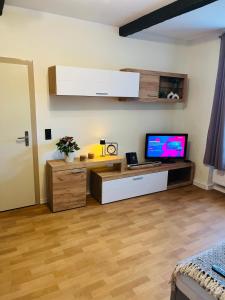 a living room with a flat screen tv on a desk at Apartment tenX Mittweida in Mittweida